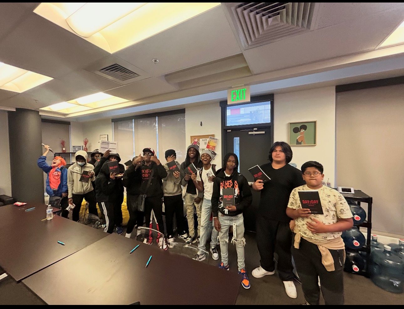 A group of young people each holding a Day2Day journal